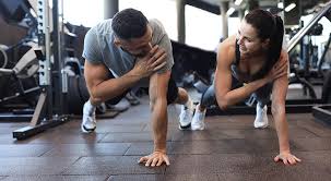 Image of man and woman doing Cardio Harrogate to tone their arms. 